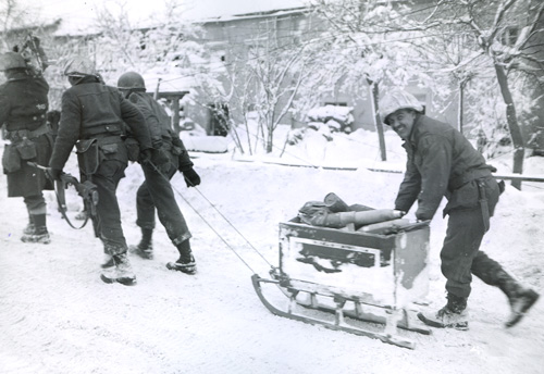 Soldiers with sled full of ammunition