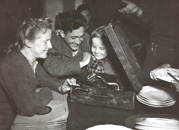 People around phonograph machine