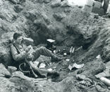 Marine reading mail in his foxhole