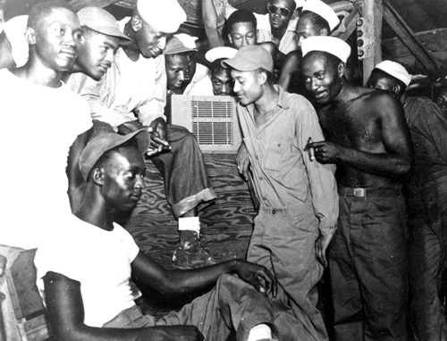 Men of 22nd Special Construction Battalion in the Admiralty Islands listen to radio acocunts of V-J Day