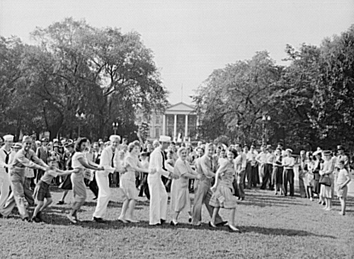 Washingtonians watch a conga line in Lafayette Square Park