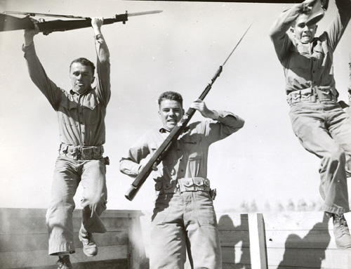 GIs with rifles on obstacle course