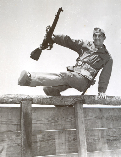 Lone GI with rifle on obstacle course