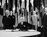 Harry Truman and Secretary of State Edward R. Stettinius, Jr., at the signing of the United Nations charter