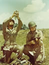 A paratrooper releases a pigeon in training for the Normandy invasion (National Archives)