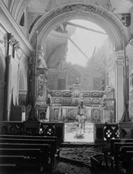 A GI standing in the bomb-damaged sanctuary of a church in Acerno, Italy, September 1943